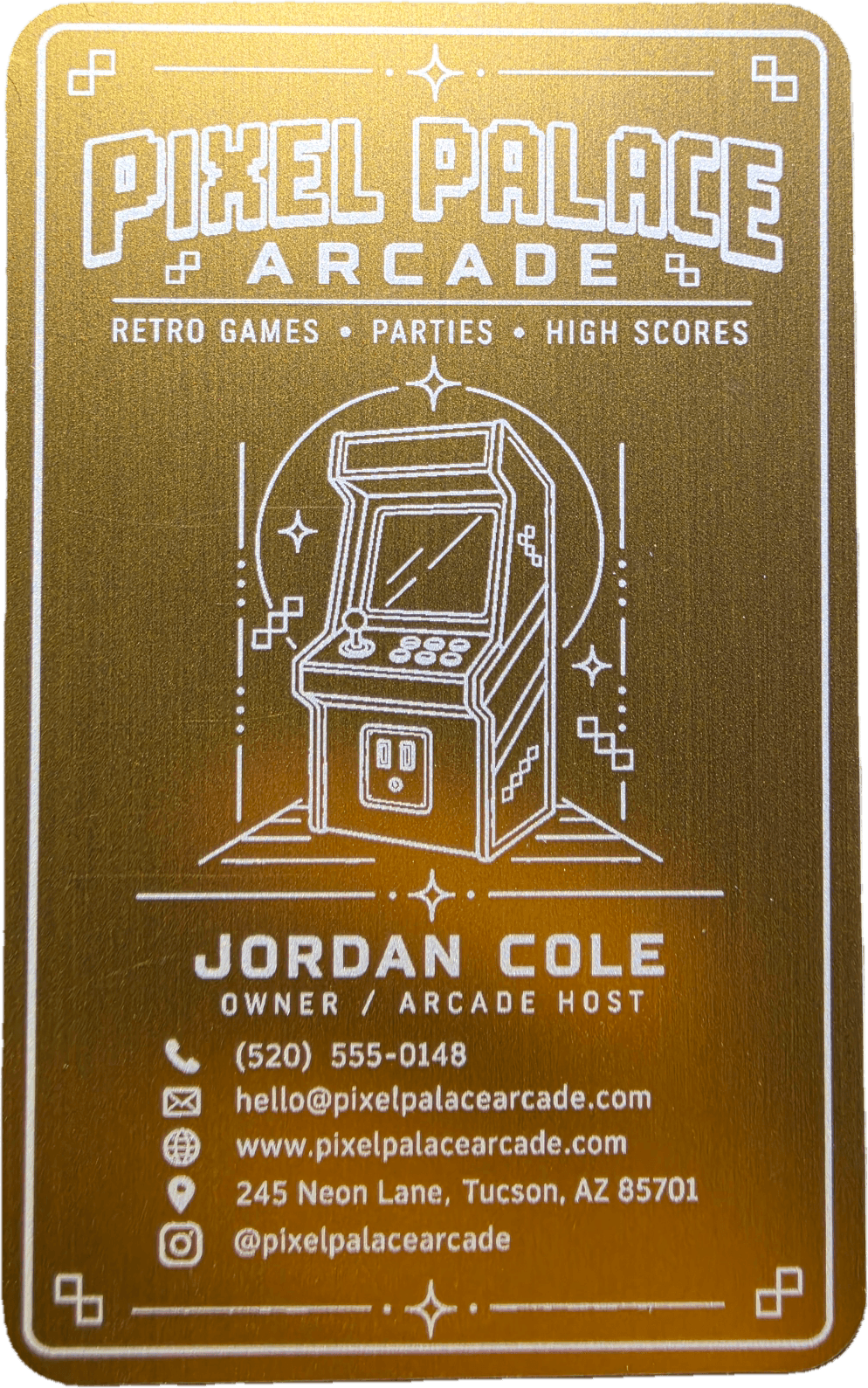Gold engraved business card with a detailed retro arcade design